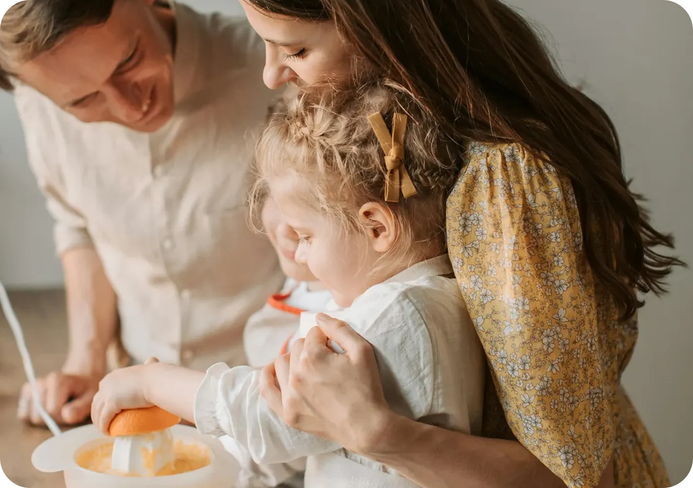 Parents and child making juice together